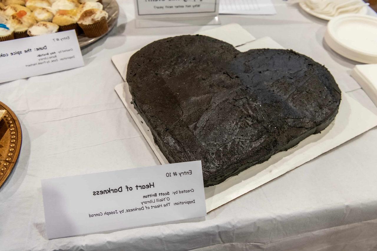a heart-shaped cake with black frosting for "Heart of Darkness"